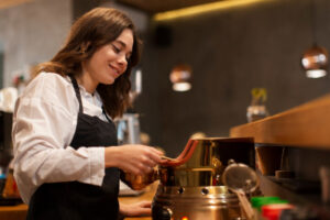 A barista using traditional-style brewing equipment to prepare premium wholesale Ethiopian coffee UK.